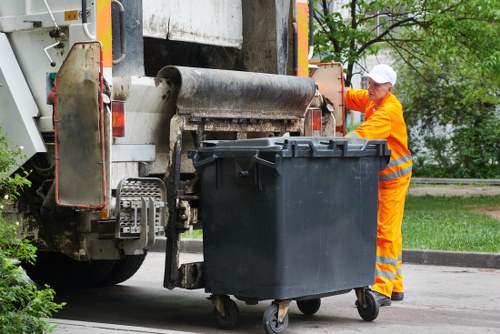 Operatives wearing PPE during waste removal and safety briefing